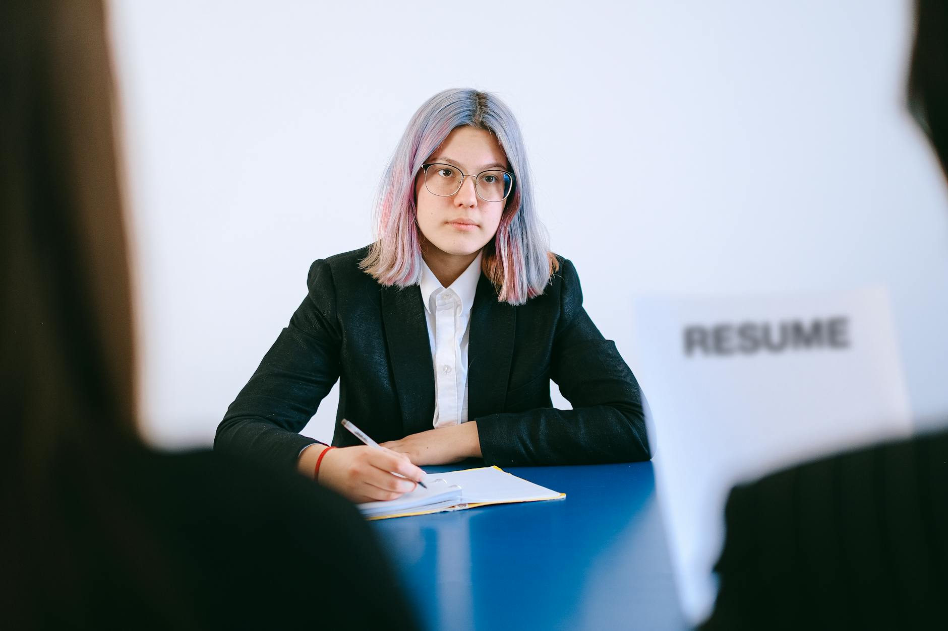 Candidate taking notes during an interview preparation session