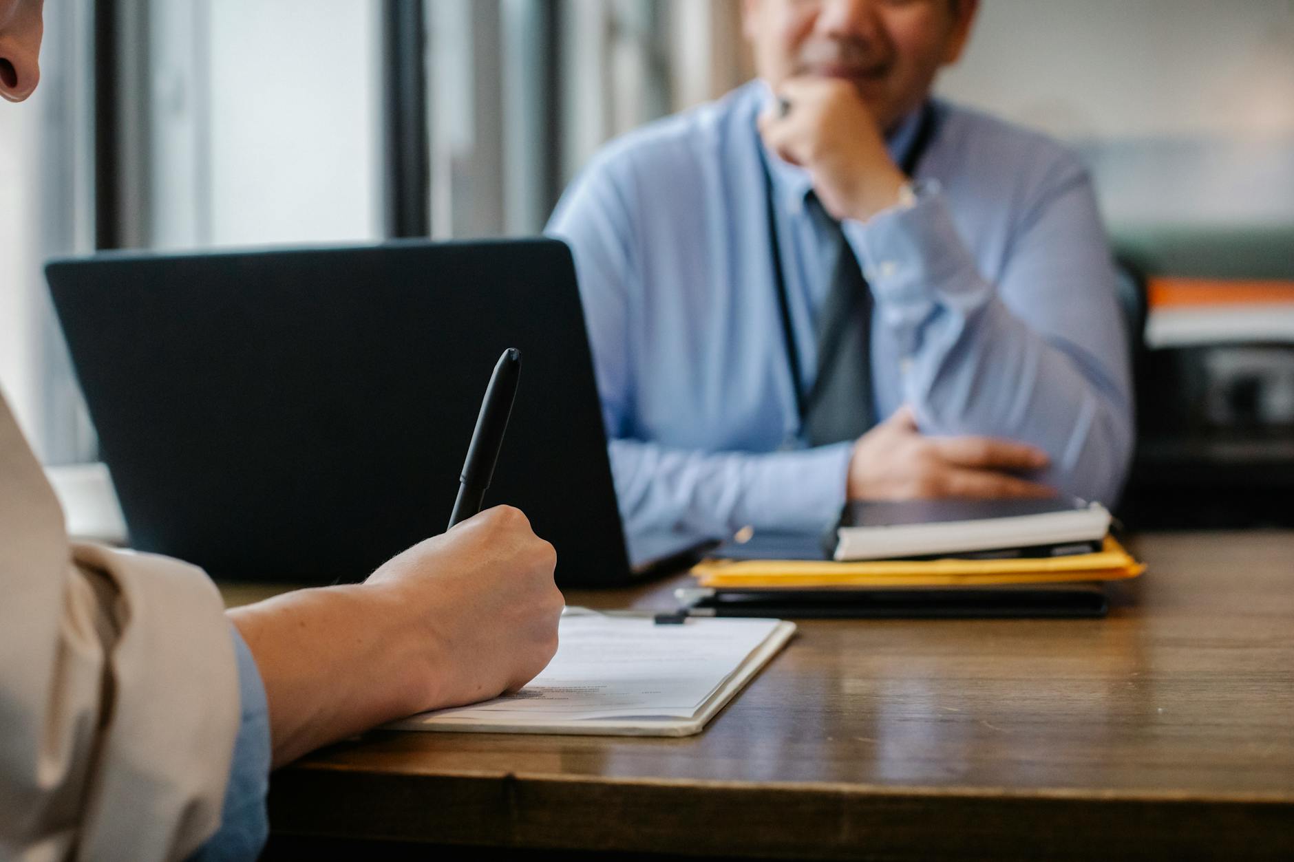 Candidate and interviewer sitting across a desk during a professional interview